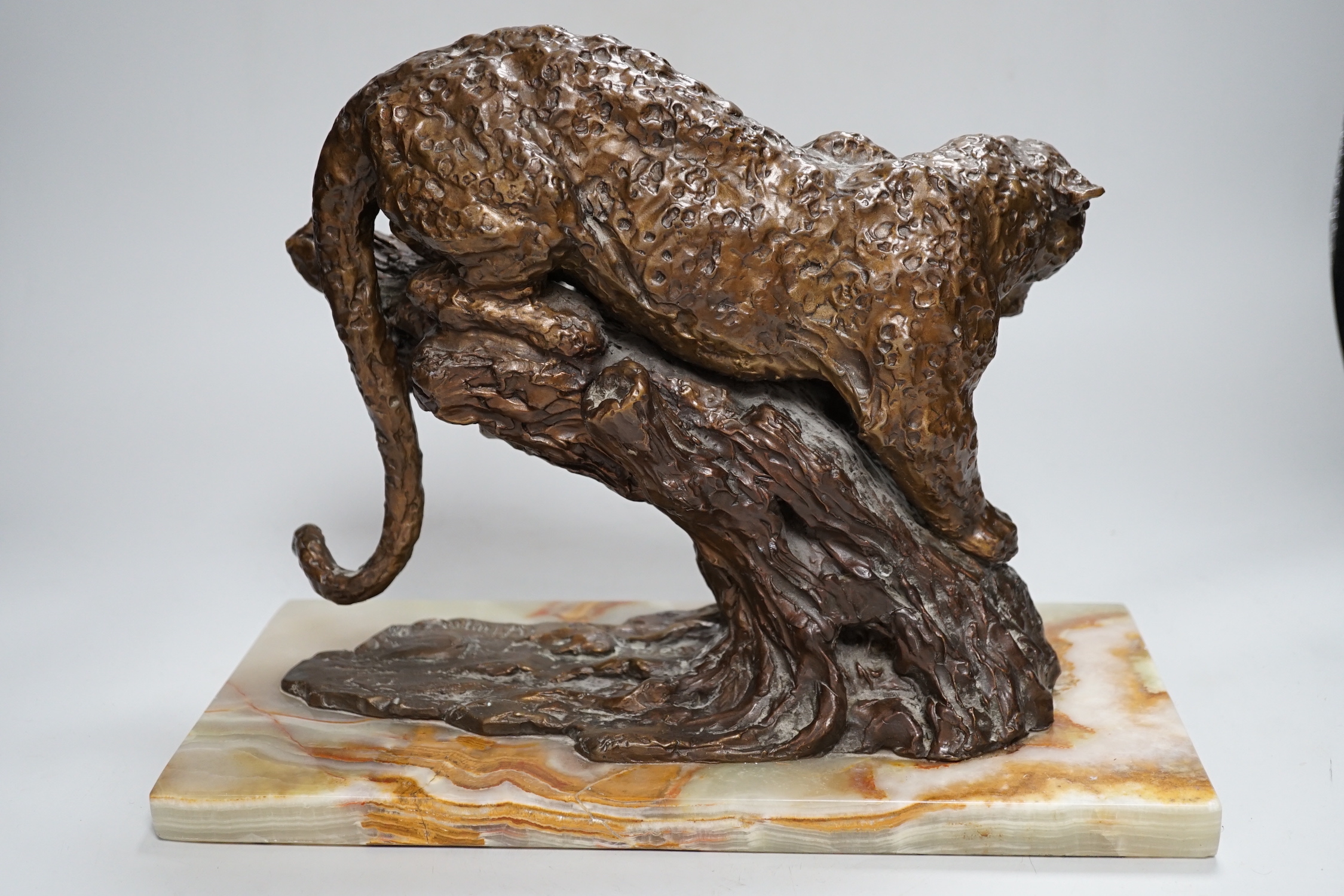 William Timym (British, 1902-1990). A bronze model of a jaguar crouched upon a tree trunk, signed in the bronze with Morris Singer foundry stamp, on green onyx plinth, 34.5cm long, deep 16cm, 25cm high